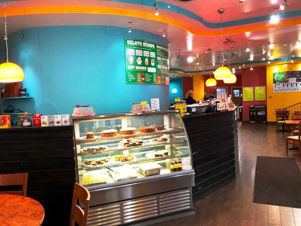 A display cabinet of cakes and desserts at the Mosque Kitchen counter