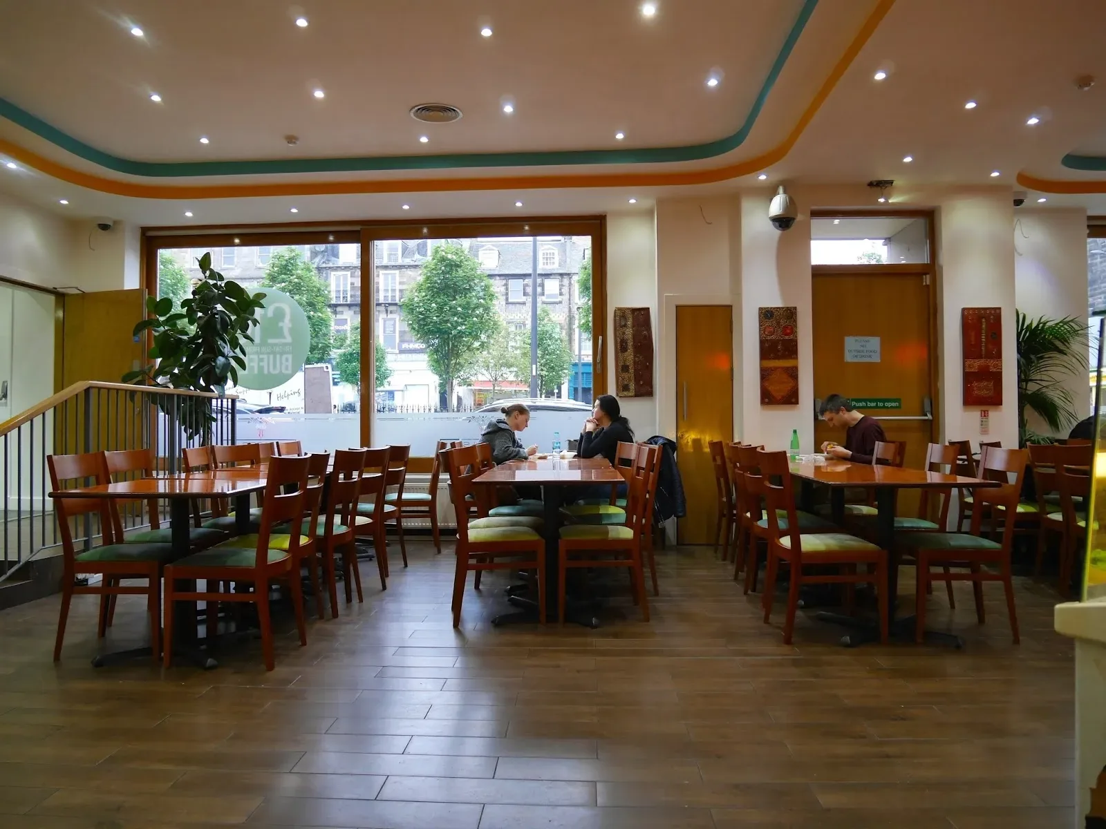 Wooden tables and chairs in the Mosque Kitchen dining room